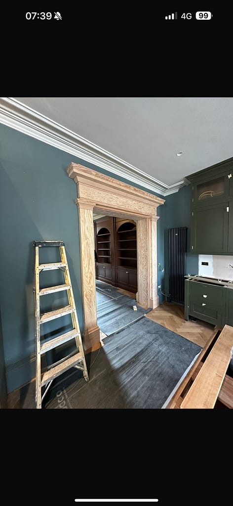 Bespoke Scottish douglas fir framing a period doorway with fitted Kitchen in a traditional Scottish home